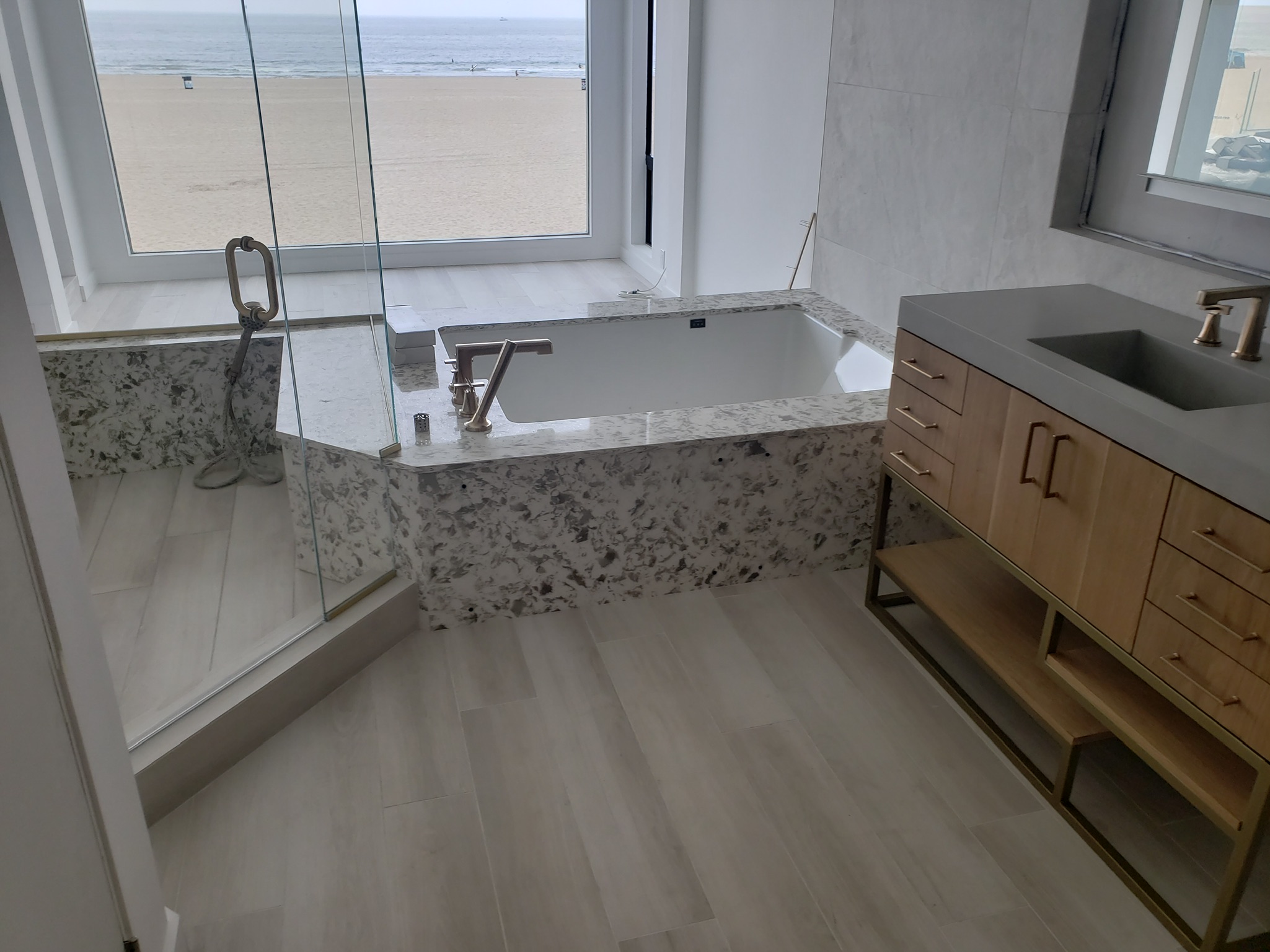 Drop-in alcove bathtub in a full wet-room bathroom overlooking Venice Beach