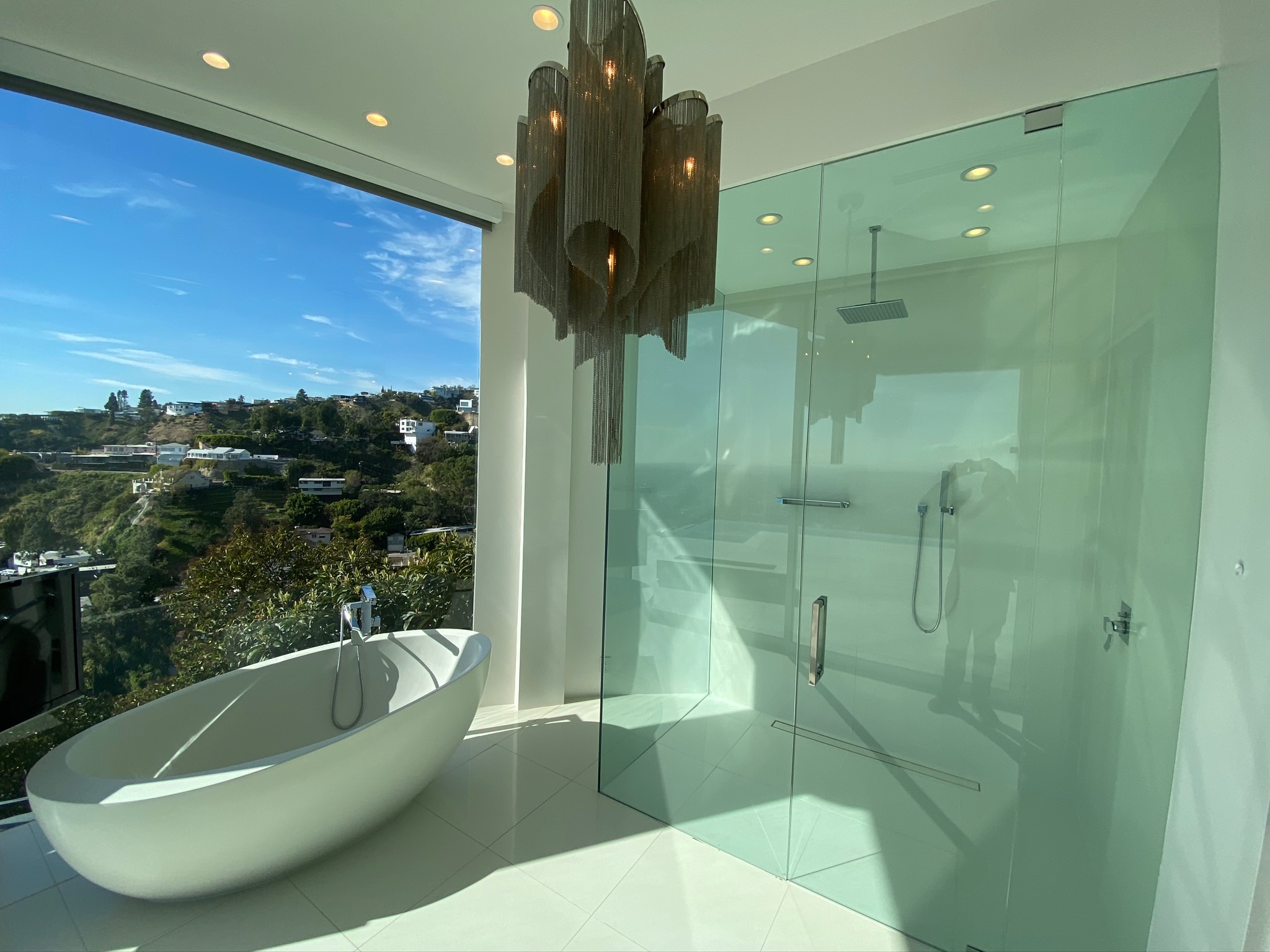Custom shower glass and porcelain tile situated over the Hollywood Hills