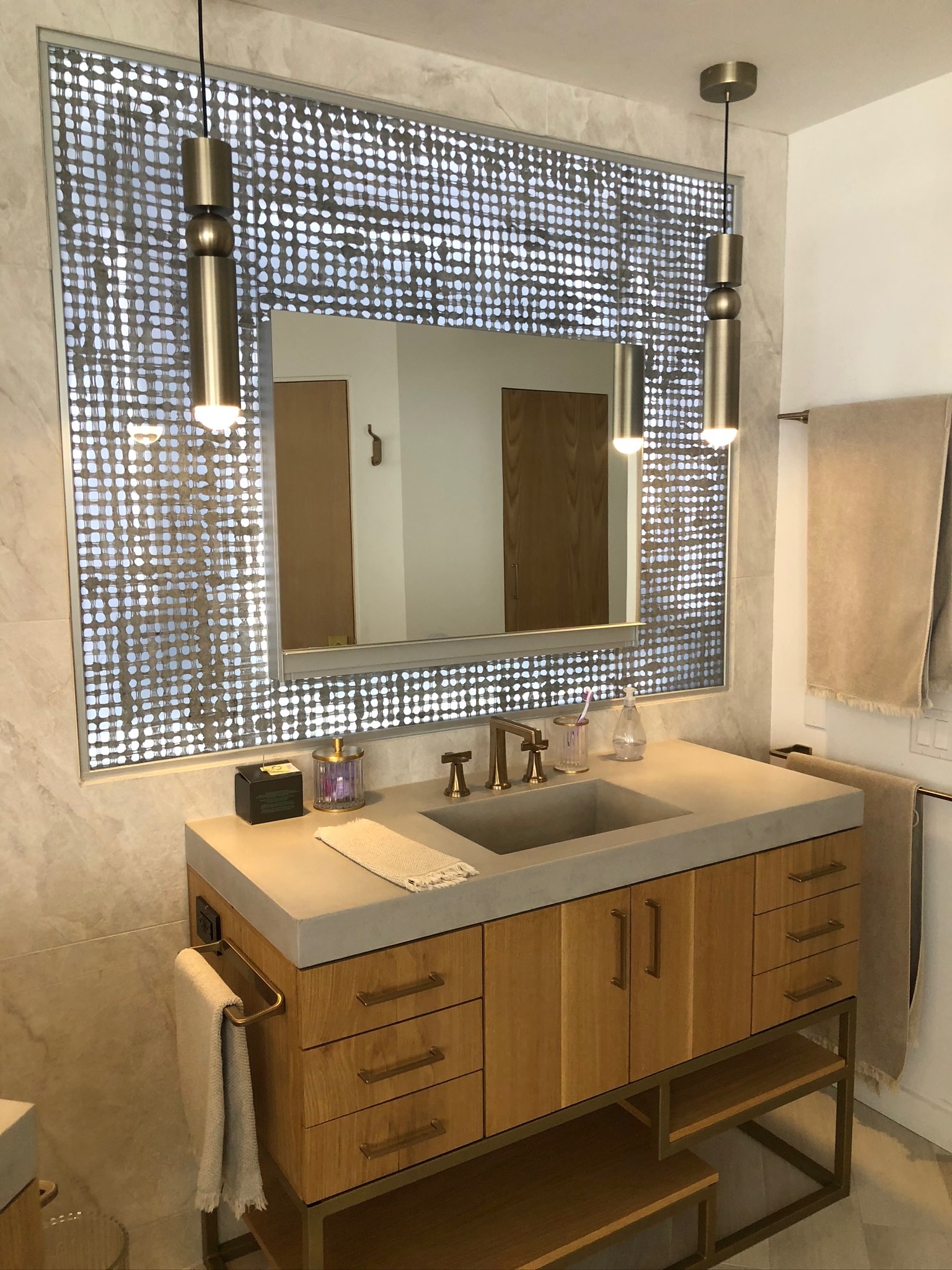 Custom wood veneer vanity with backlit penny tile in Venice Beach