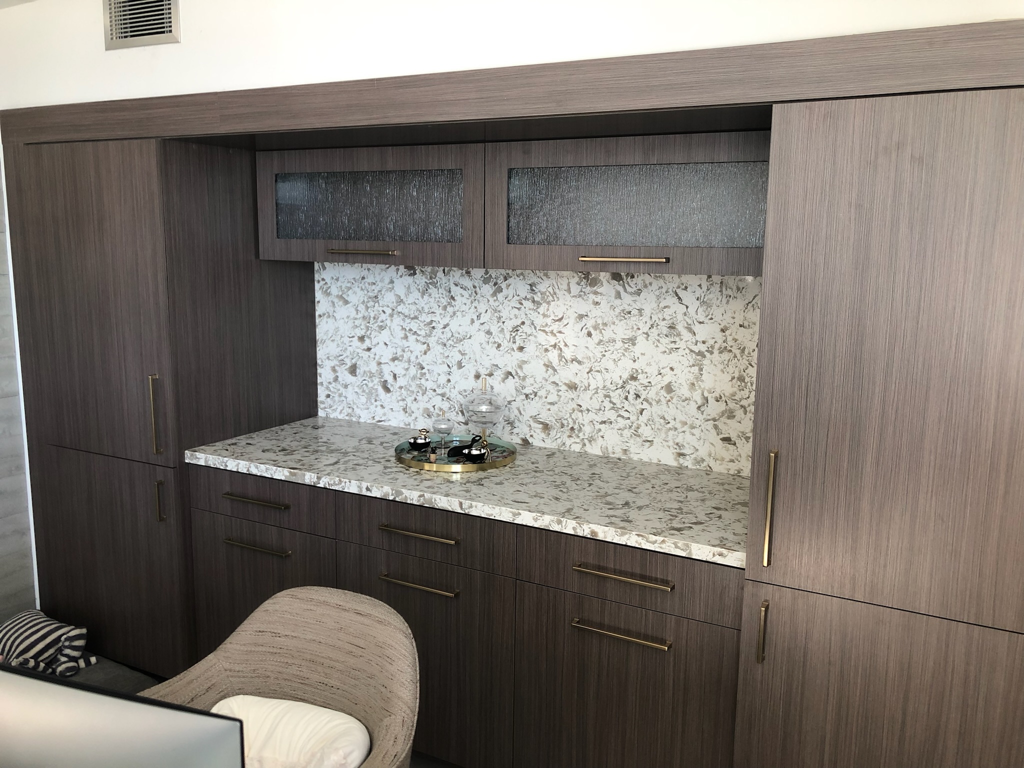 Custom dark wood cabinetry with a stone countertop by RMK Builders